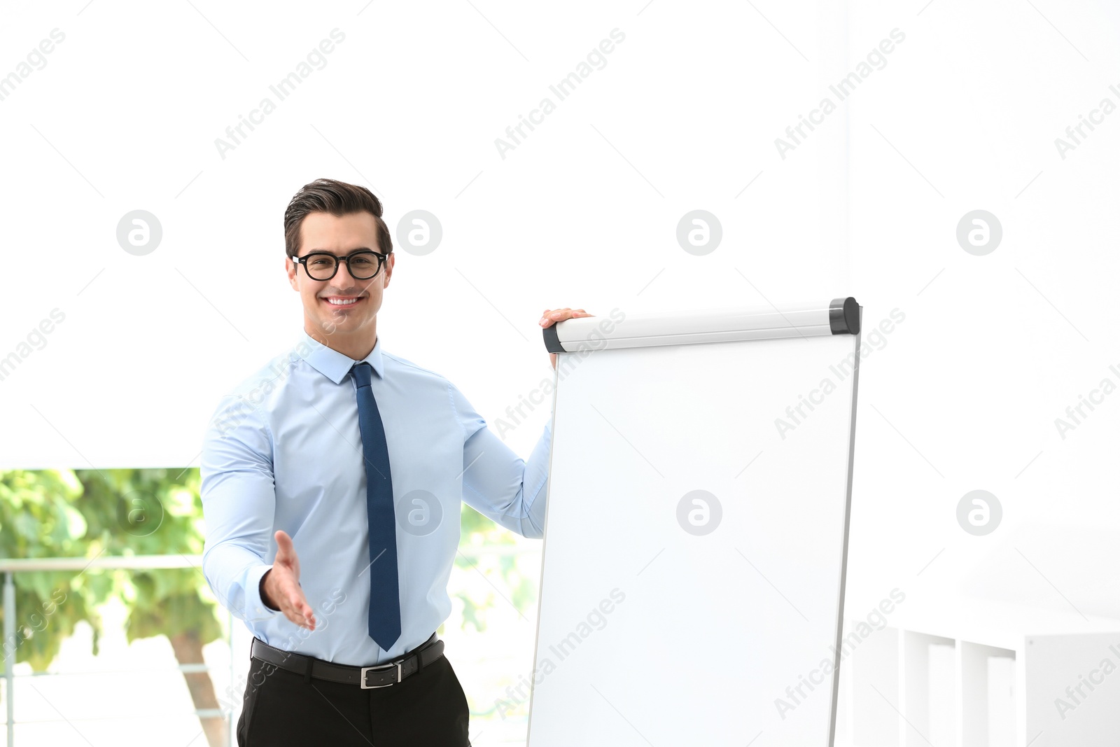 Photo of Professional business trainer near flip chart in office