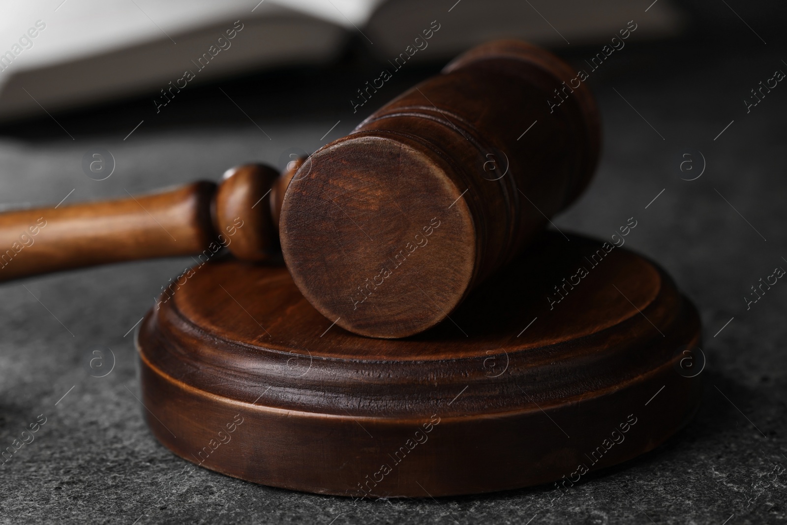 Photo of Law concept. Judge's gavel on grey textured table, closeup