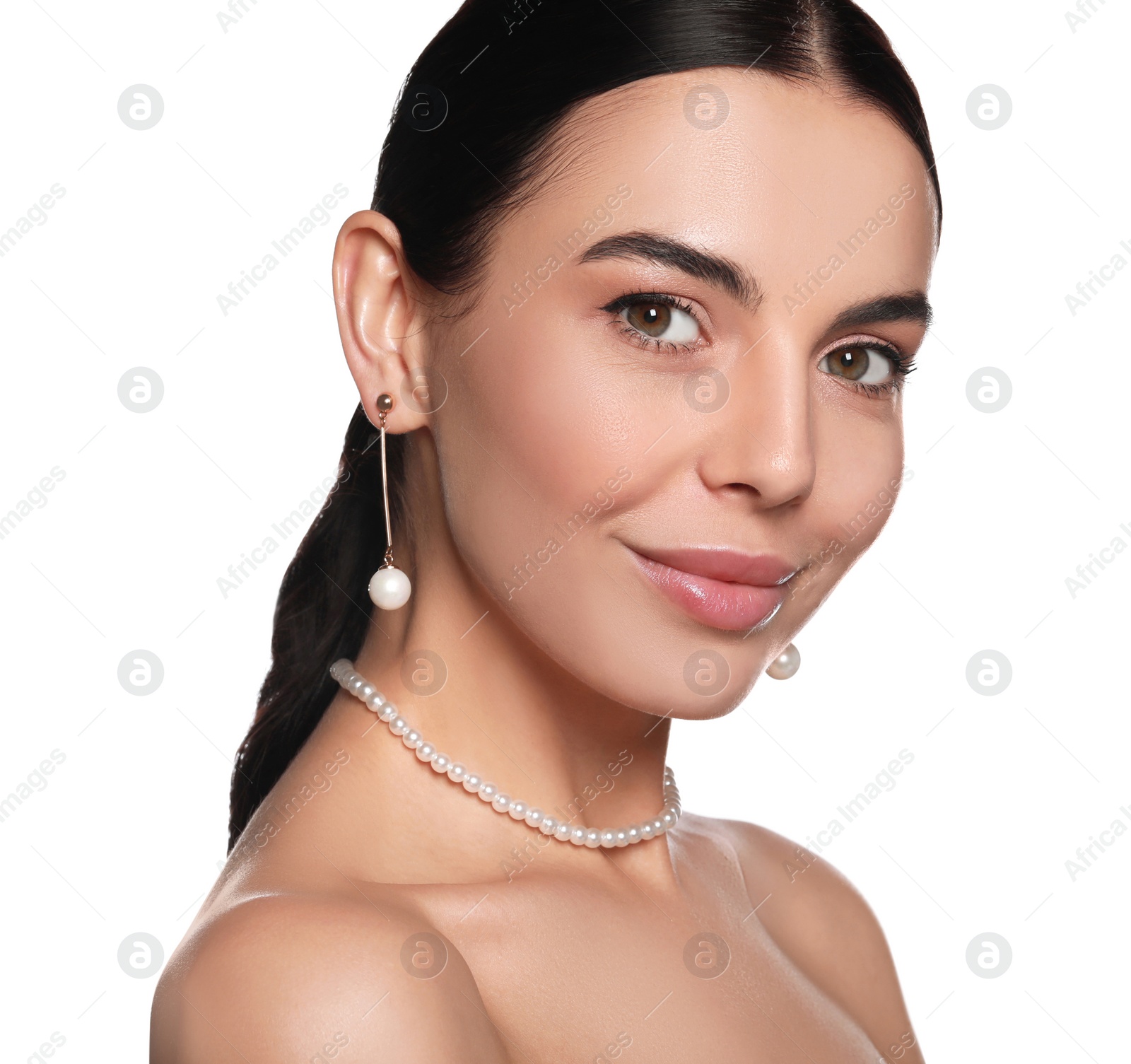 Photo of Young woman wearing elegant pearl jewelry on white background