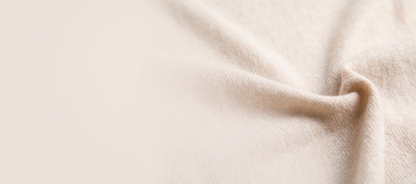 Image of Warm cashmere fabric as background, closeup view with space for text. Banner design