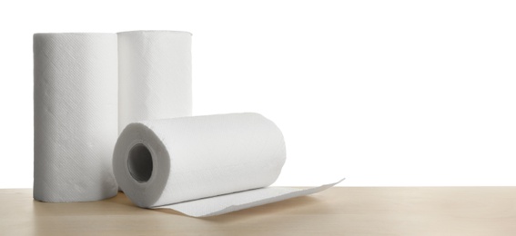 Photo of Rolls of paper tissues on wooden table