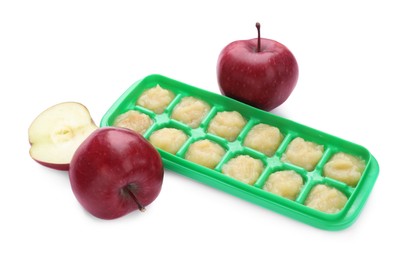 Photo of Apple puree in ice cube tray and fresh apple fruits isolated on white. Ready for freezing