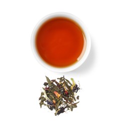 Photo of Freshly brewed tea and dry leaves on white background, top view