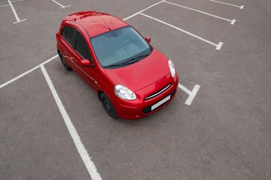 Photo of Modern red car on parking lot outdoors