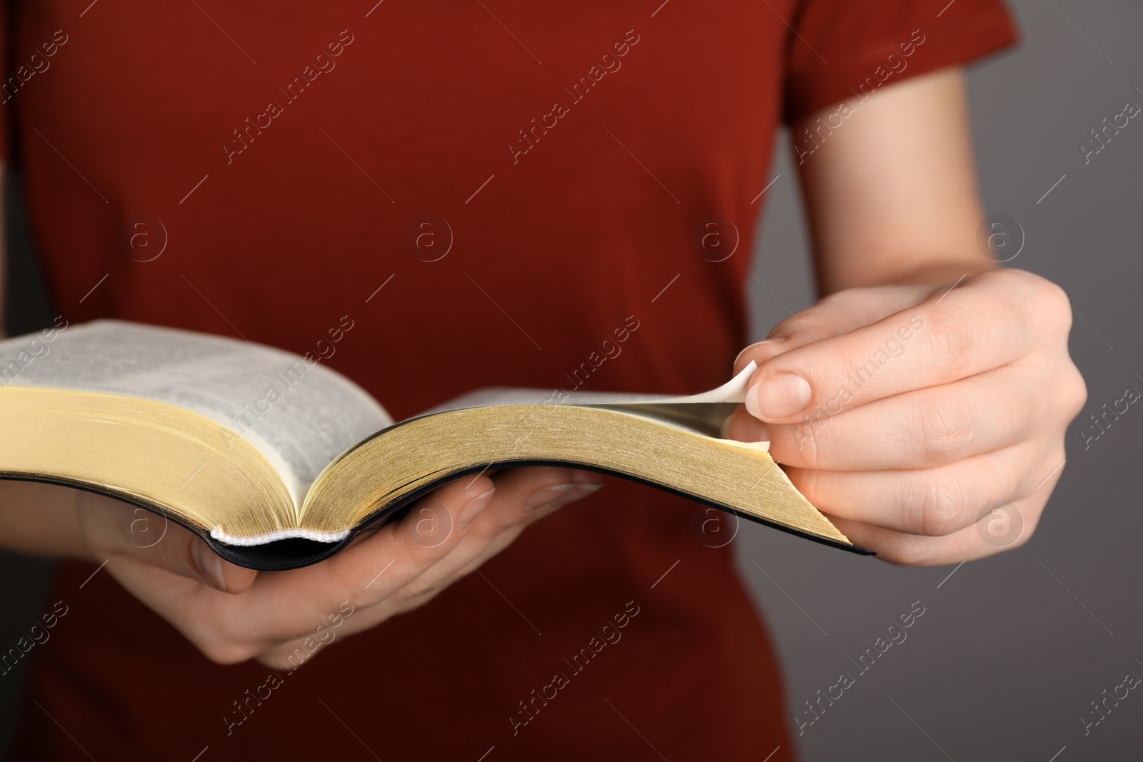 Photo of Humble woman reading Bible, closeup. Religious literature