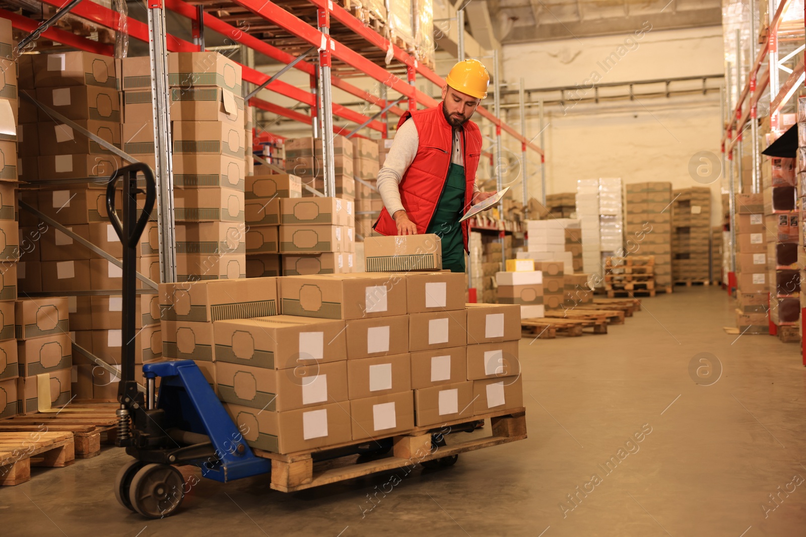 Image of Man with tablet working at warehouse. Logistics center