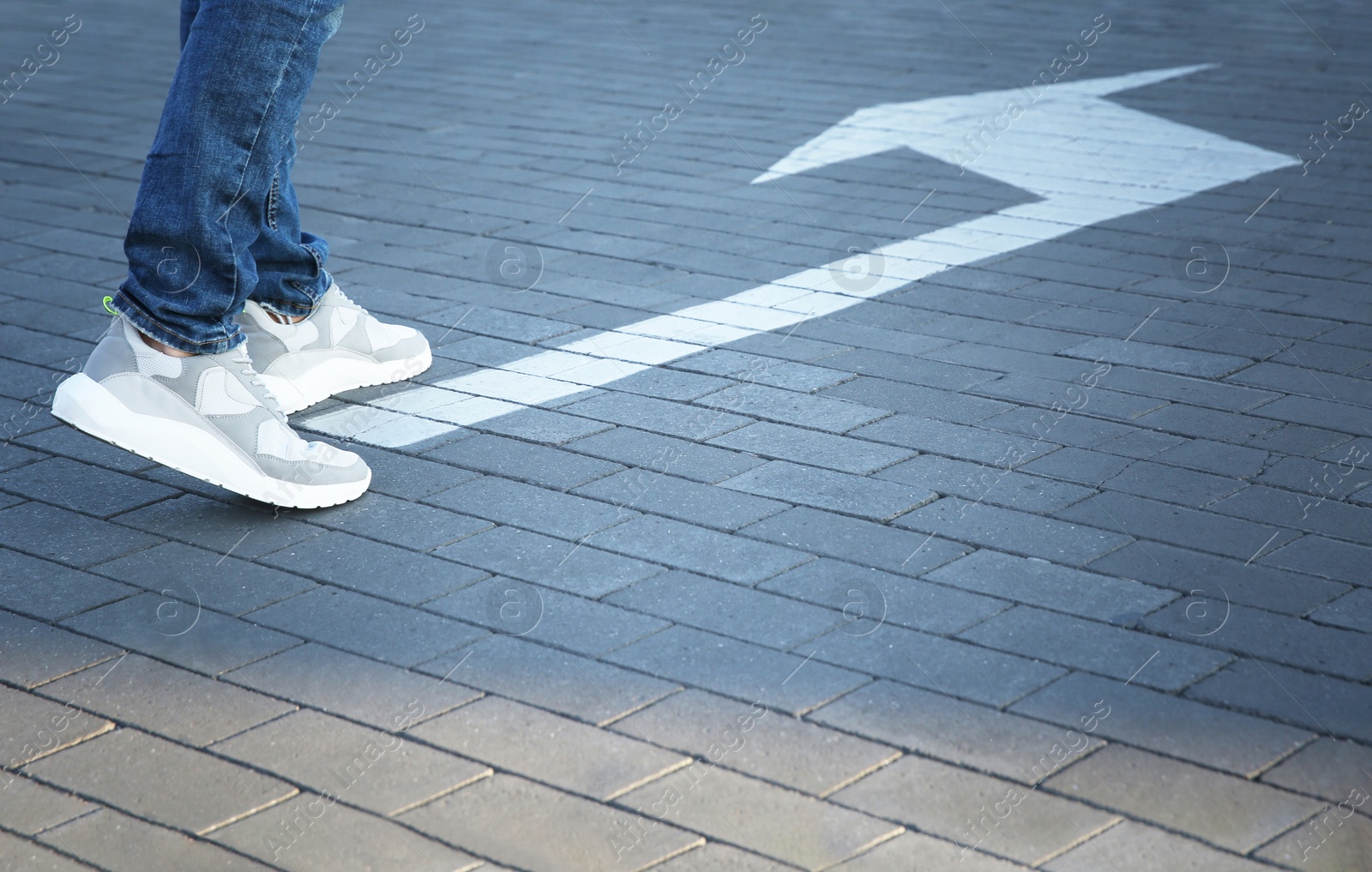 Photo of Man going along road with arrow marking, closeup