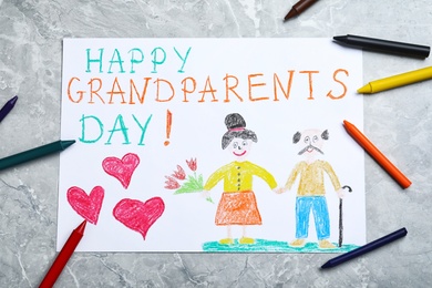 Photo of Beautiful drawing on grey marble table, flat lay. Happy Grandparents Day