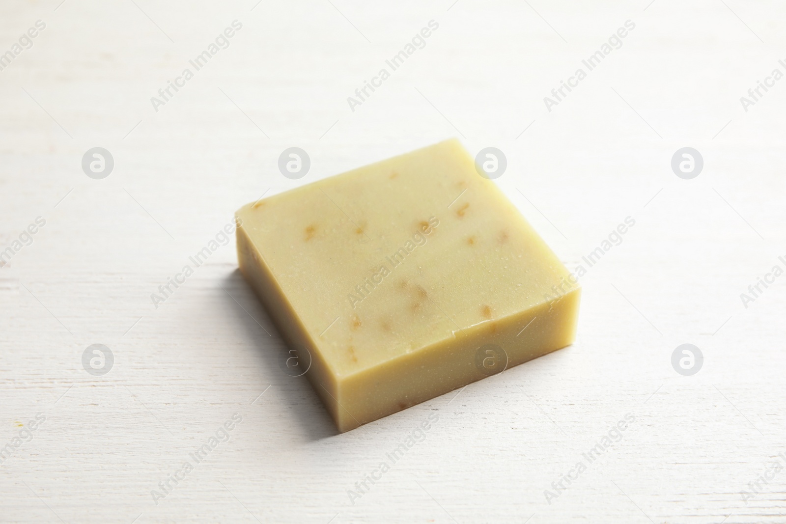 Photo of Hand made soap bar on white wooden background