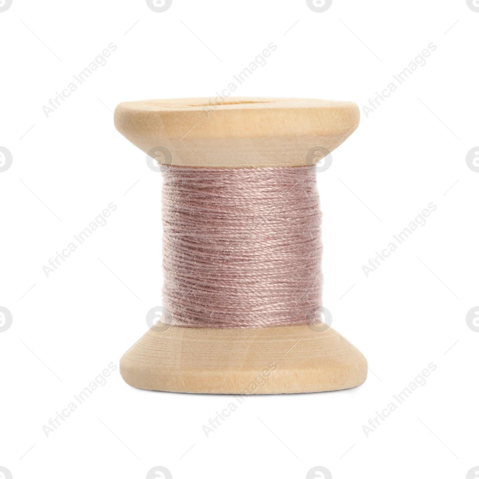 Photo of Wooden spool of pink sewing thread isolated on white