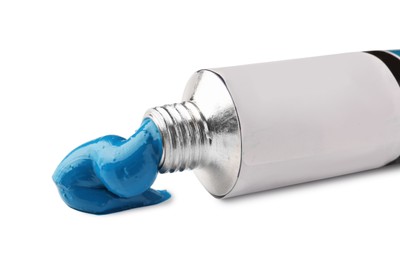 Photo of Tube with blue oil paint on white background