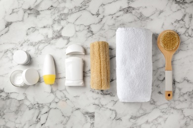 Photo of Flat lay composition with natural deodorants and bath accessories on white marble table