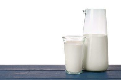 Photo of Glassware with tasty milk on blue wooden table against white background
