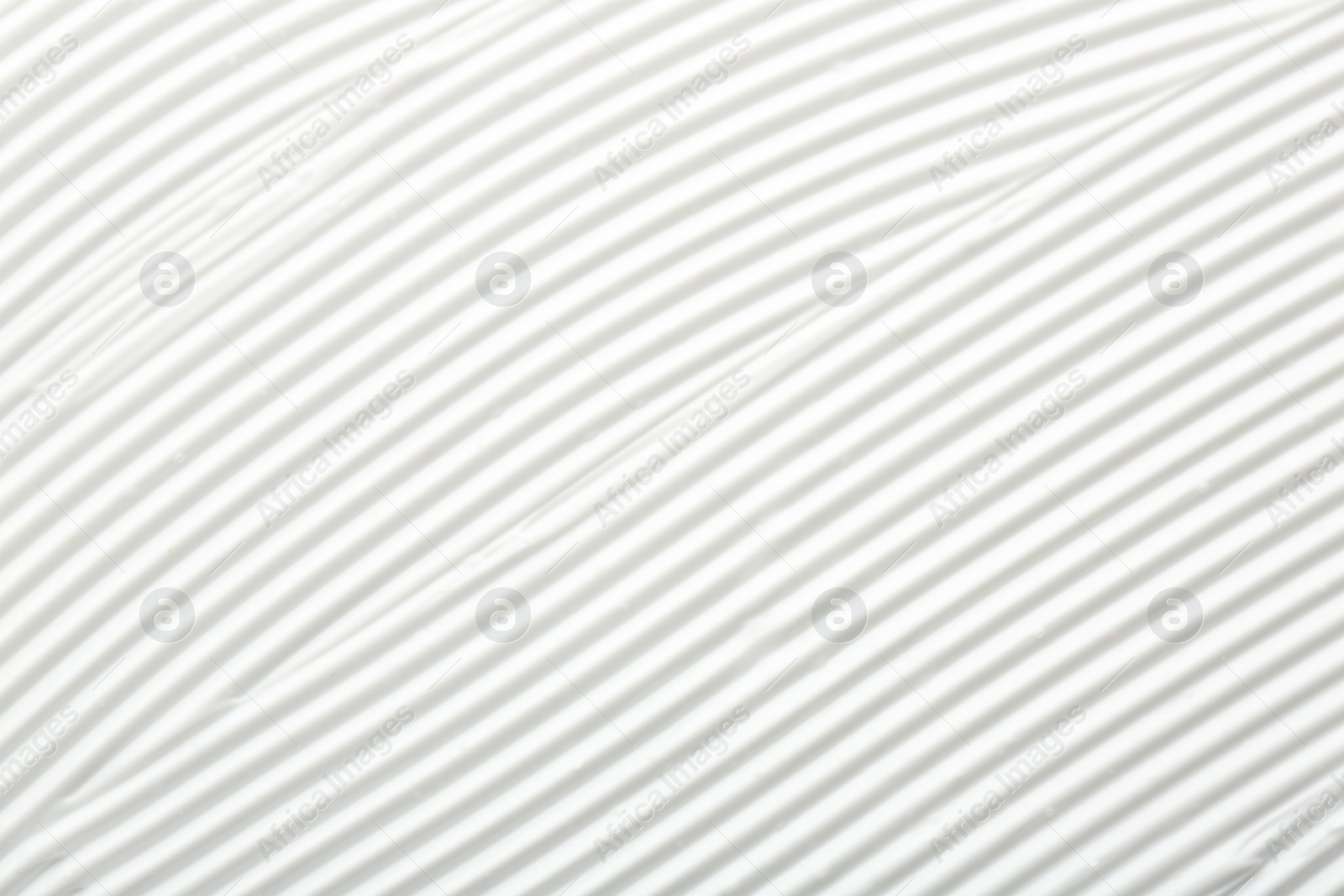 Photo of Texture of face care cream as background, top view