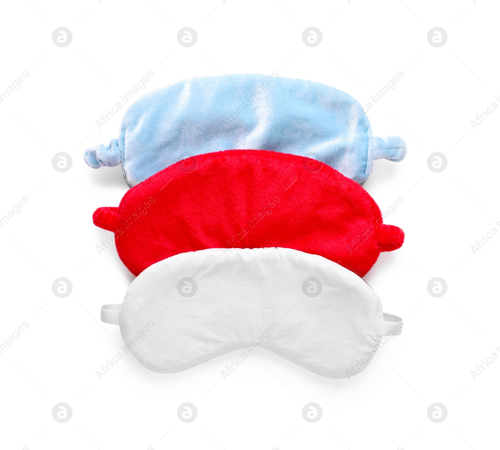 Photo of Three soft sleep masks isolated on white, top view