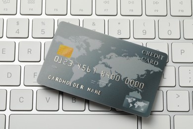Online payment concept. Bank card on computer keyboard, closeup