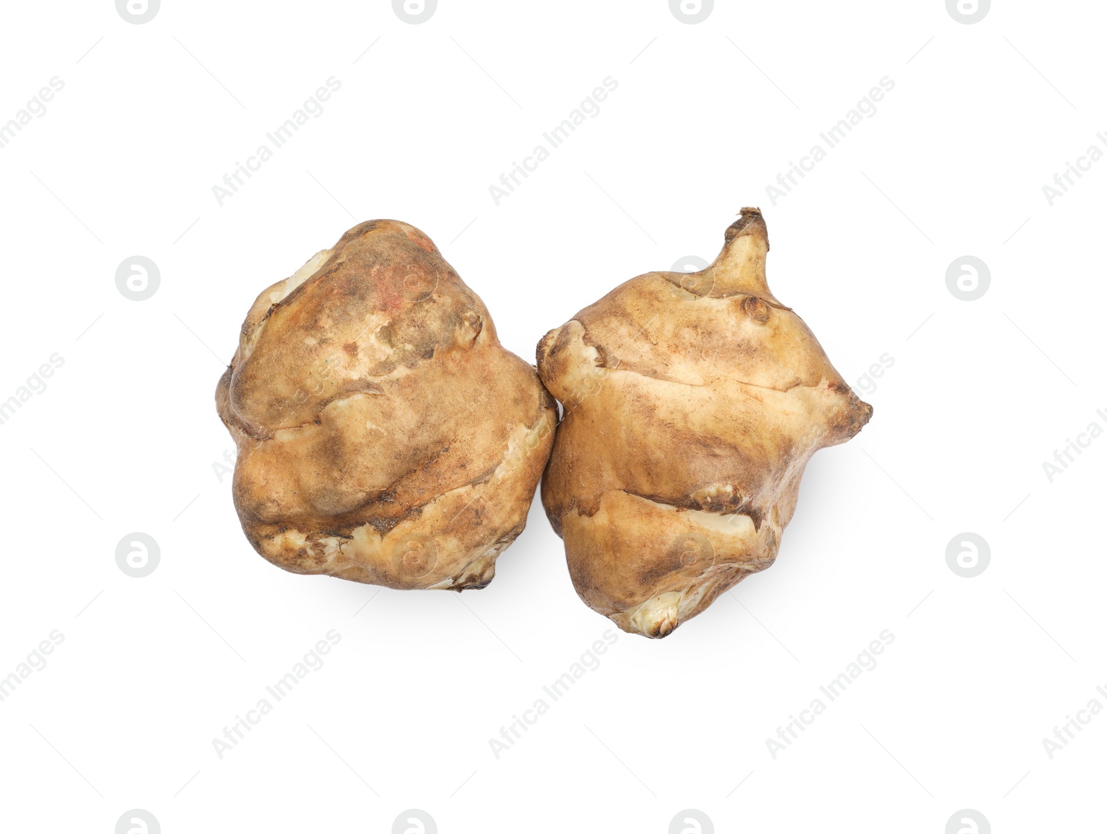 Photo of Jerusalem artichokes isolated on white, top view