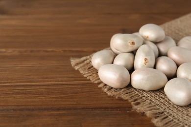 Raw jackfruit seeds on wooden table. Space for text