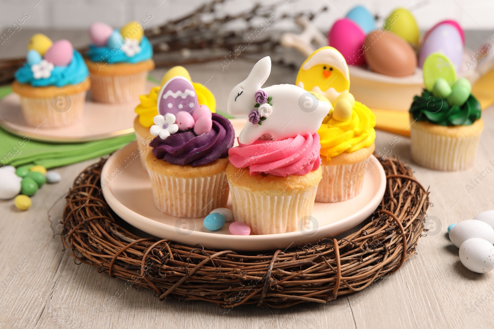 Photo of Tasty decorated Easter cupcakes on wooden table