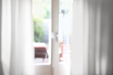 Photo of Blurred view of glass door at home
