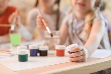 Cute little children painting at table indoors, closeup. Learning by playing