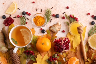 Flat lay composition with cup of delicious immunity boosting tea and ingredients on color textured background