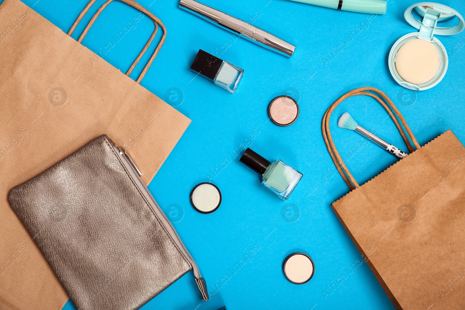 Photo of Flat lay composition with shopping bags and cosmetics on color background