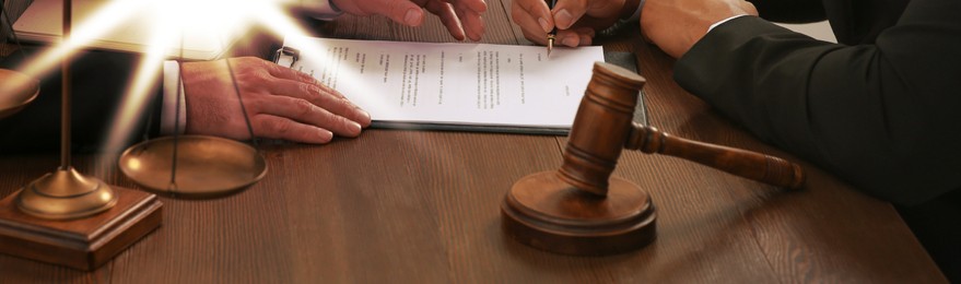 Image of Law and justice. People working with documents at wooden table, closeup. Banner design