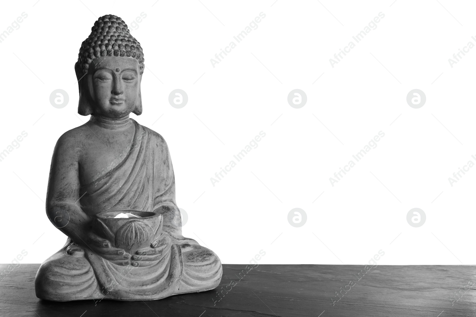 Photo of Beautiful stone Buddha sculpture on table against grey background. Space for text