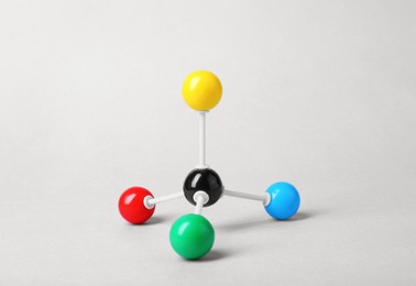 Photo of Molecular atom model on light grey background. Chemical structure