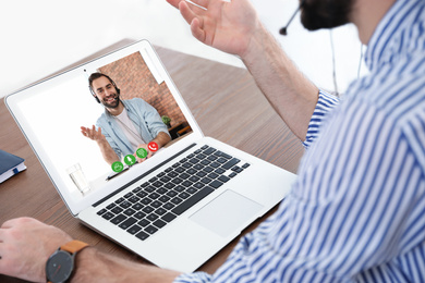 Man using video chat for online job interview in office, closeup 