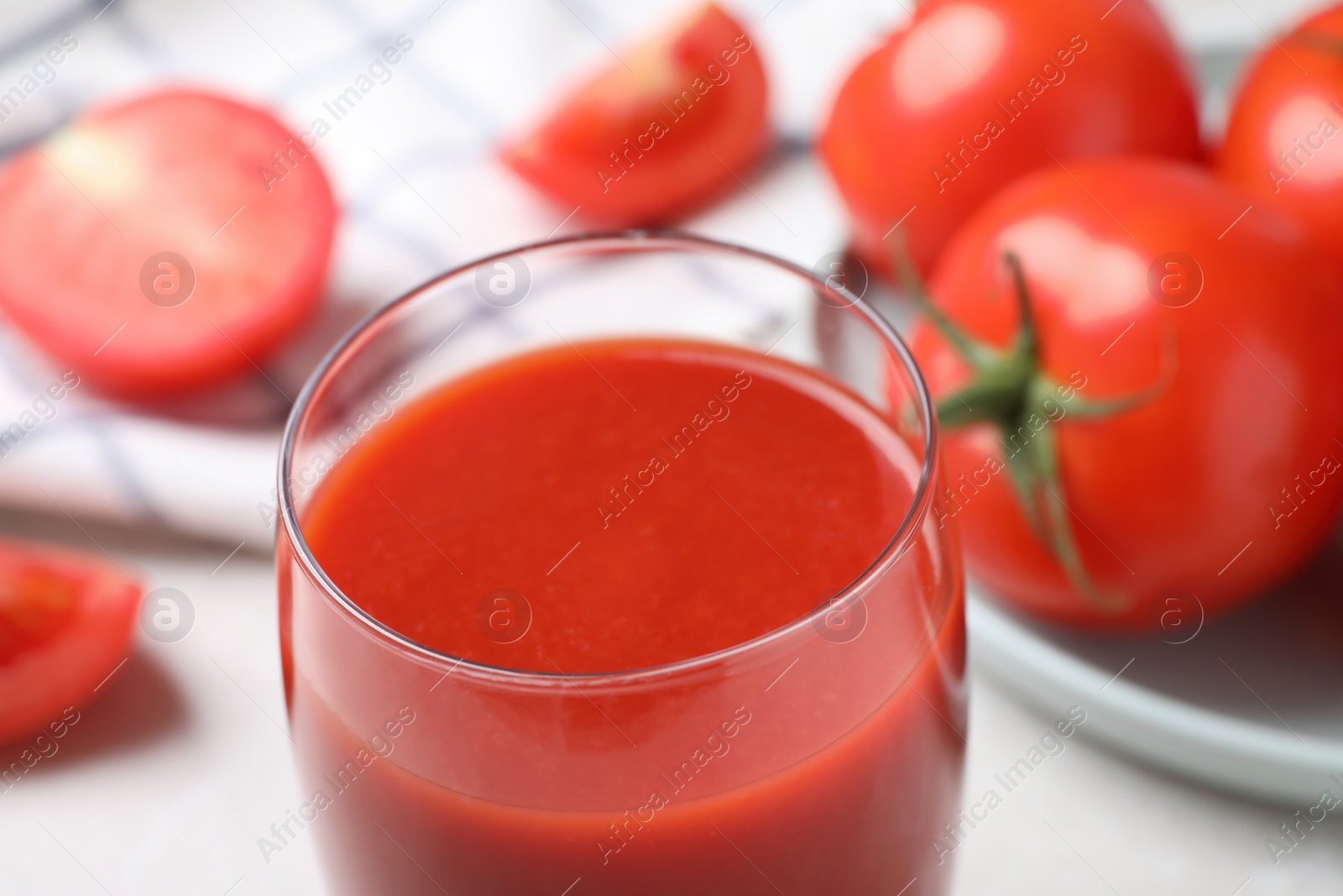 Photo of Delicious fresh tomato juice in glass, closeup