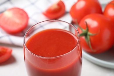 Photo of Delicious fresh tomato juice in glass, closeup