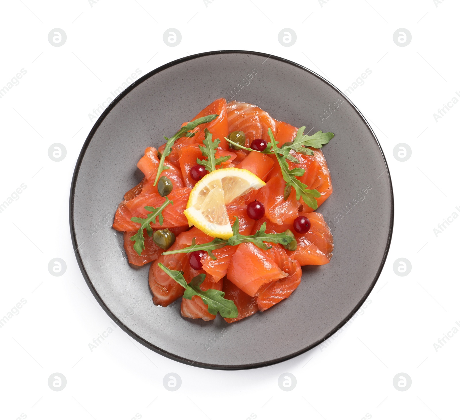 Photo of Salmon carpaccio with capers, cranberries, arugula and lemon isolated on white, top view