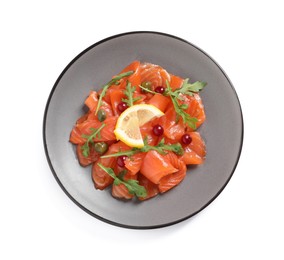 Salmon carpaccio with capers, cranberries, arugula and lemon isolated on white, top view