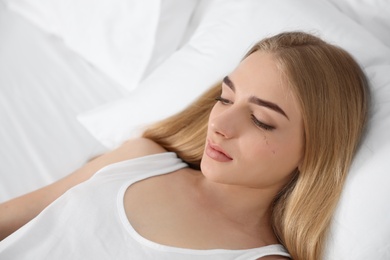 Photo of Young woman with eyelash loss problem resting in bed