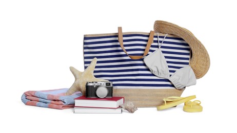 Photo of Stylish bag, camera, books and other beach accessories isolated on white