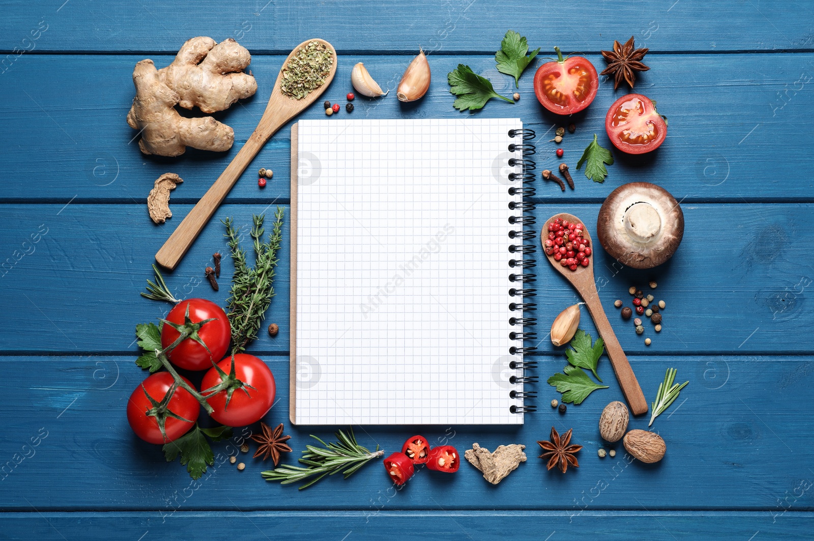 Photo of Open recipe book and different ingredients on light blue wooden table, flat lay. Space for text