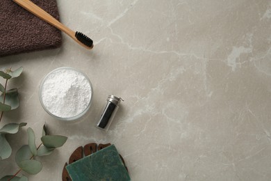 Photo of Flat lay composition with tooth powder and eucalyptus on light grey table, space for text