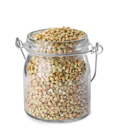 Photo of Uncooked green buckwheat grains in jar isolated on white