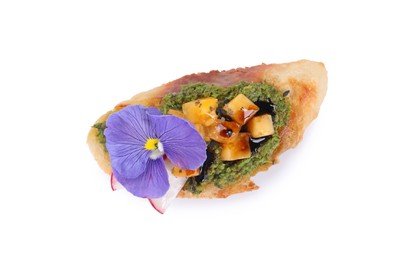 Delicious bruschetta with pesto sauce, tomatoes, balsamic vinegar and violet flower on white background, top view