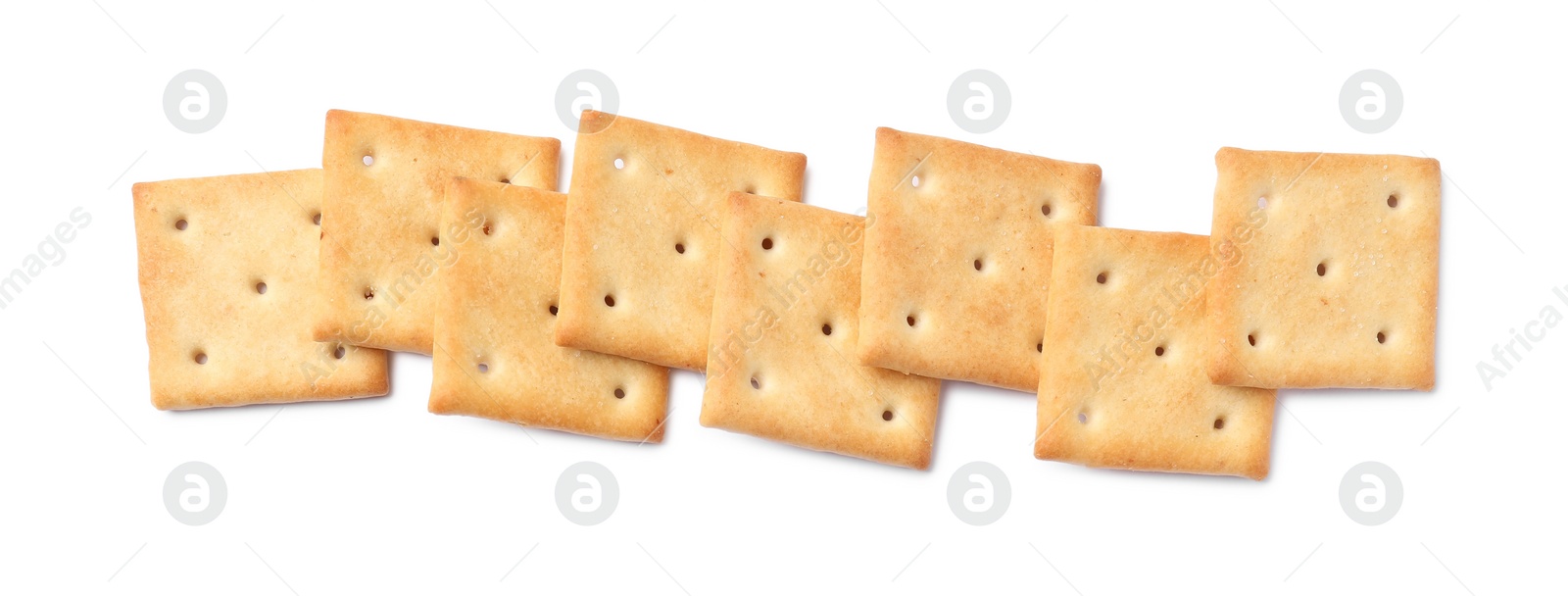 Photo of Tasty crispy square crackers isolated on white, top view