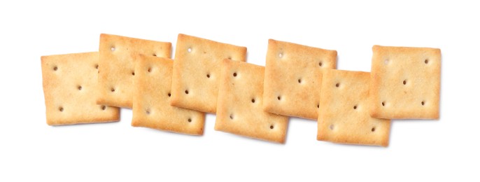 Tasty crispy square crackers isolated on white, top view