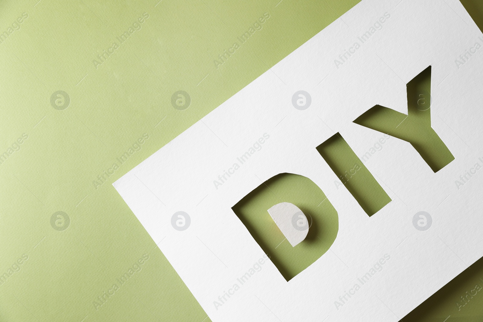 Photo of Stencil with abbreviation DIY on olive background, top view. Space for text