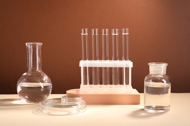Laboratory analysis. Different glassware on table against brown background