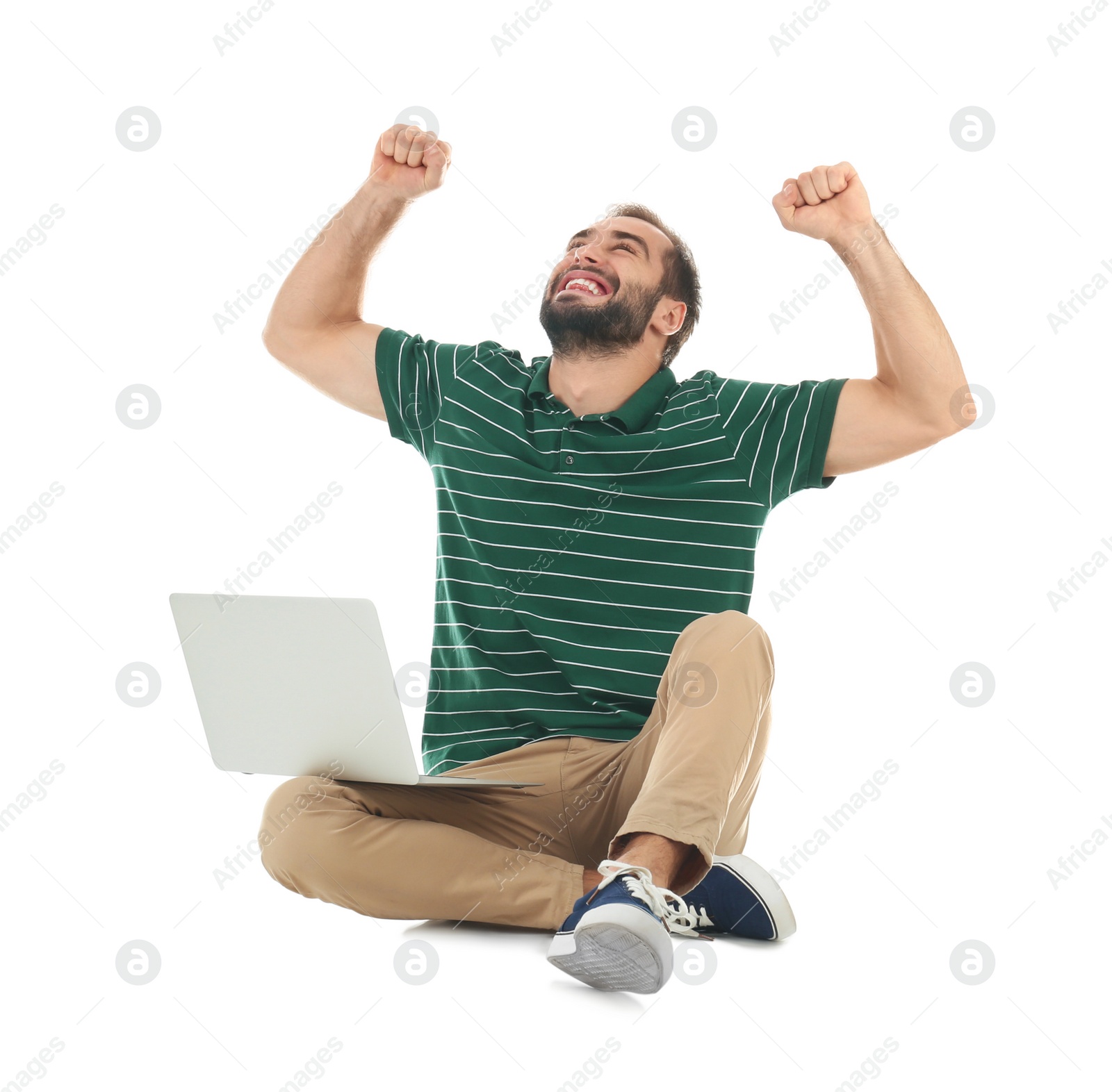 Photo of Emotional young man with laptop celebrating victory on white background