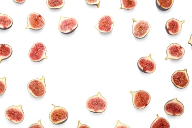 Photo of Frame made of cut ripe figs on white background, top view. Space for text