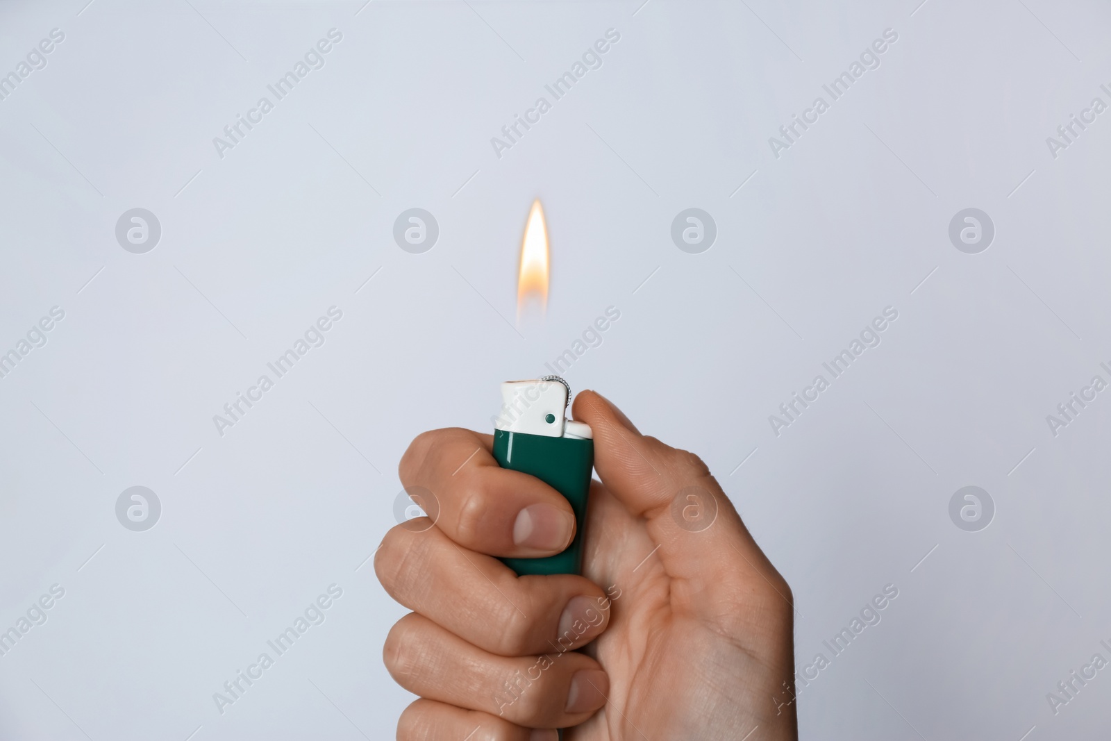 Photo of Woman holding lighter on white background, closeup