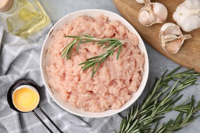 Photo of Flat lay composition with fresh raw minced meat and rosemary on light grey table