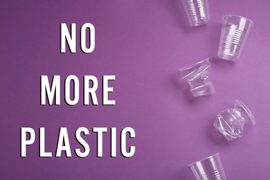 Text NO MORE PLASTIC and different disposable cups on violet background, flat lay